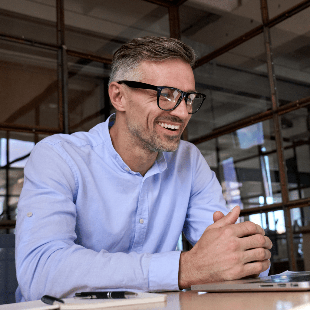 Happy mature business man executive manager looking at laptop computer watching online webinar or having remote virtual meeting, video conference call