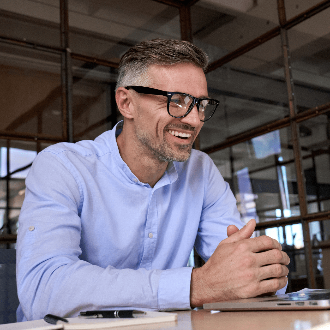 Happy mature business man executive manager looking at laptop computer watching online webinar or having remote virtual meeting, video conference call