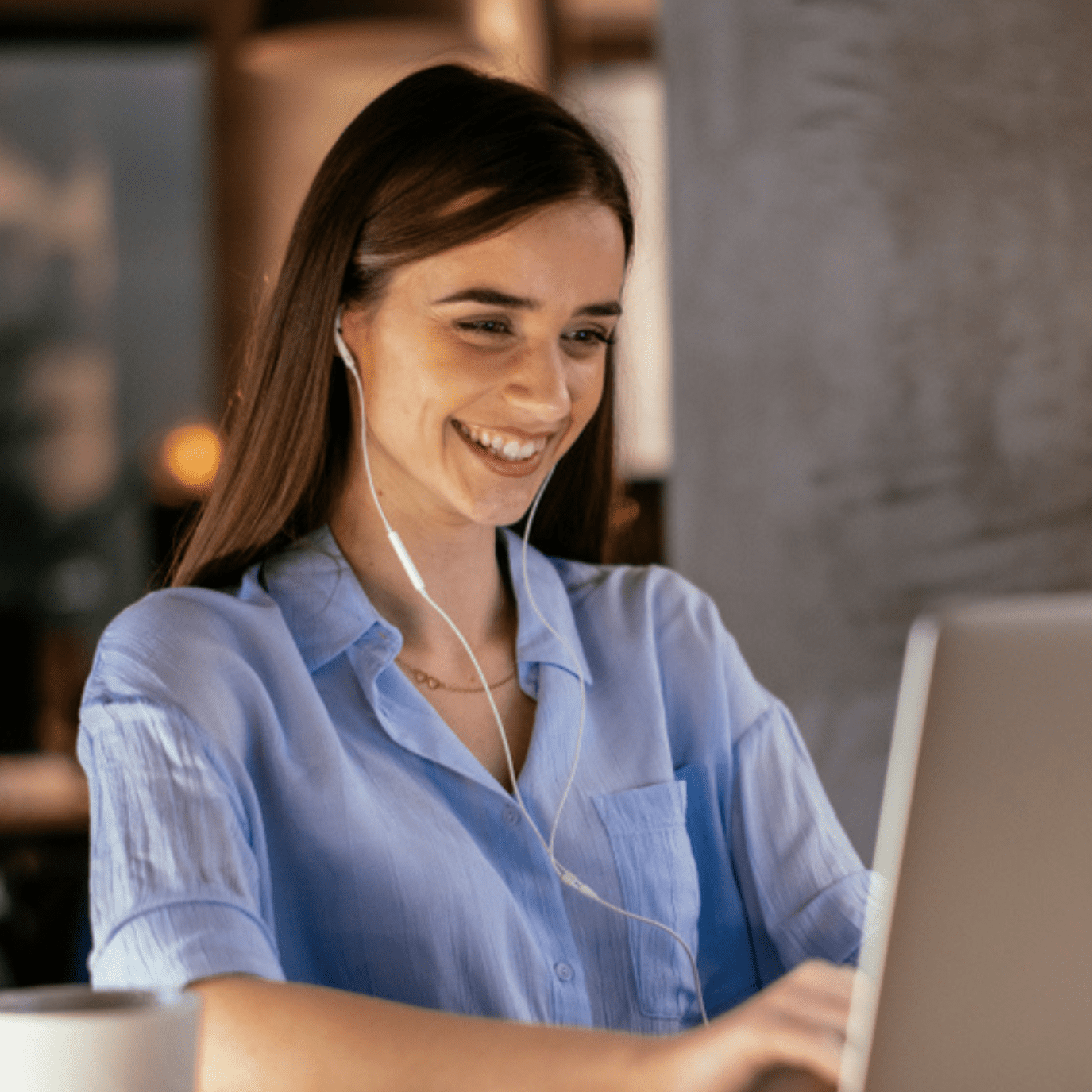Business woman working on the laptop in the office. Young girl sitting in conference room with laptop. Smiling girl in office space working.