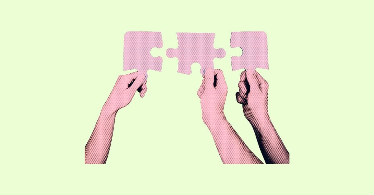 three hands holding puzzle pieces